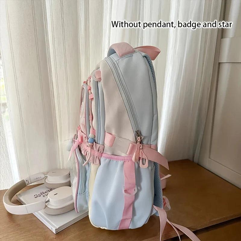 Pastel mini backpack with front zipper and side ribbons, shown from back angle