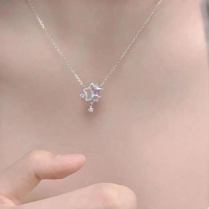 Star pendant necklace with iridescent center stone and small dangling star charm on chain