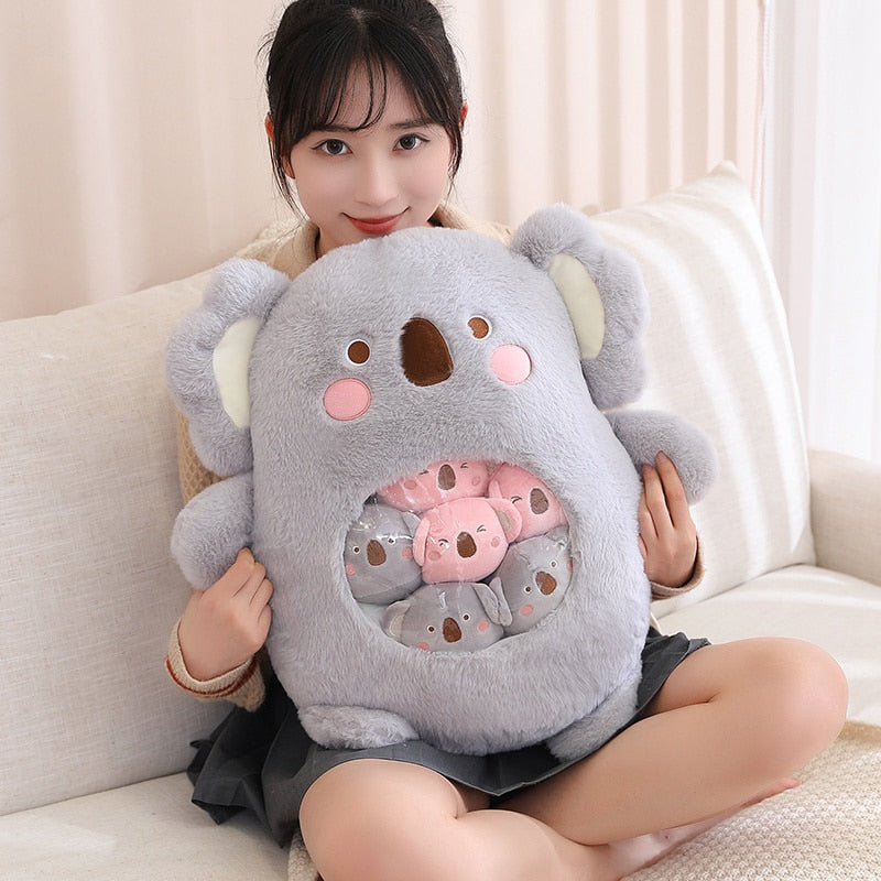 Plush animal shaped pillow in light grey, koala face design with inner pastel graphic