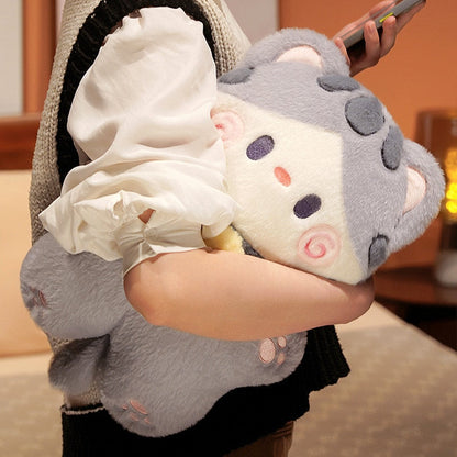 Grey cat-shaped plush pillow in a bag, with pink swirl face and rounded ears