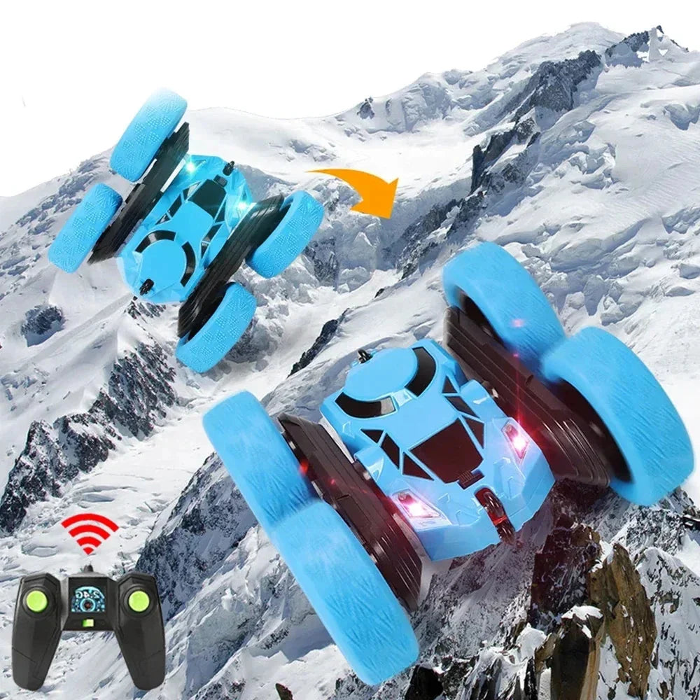 Blue RC stunt car with large foam tires and handheld 2.4G remote controller