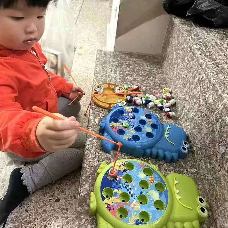 Child playing with blue and green dinosaur magnetic fishing toy on the floor