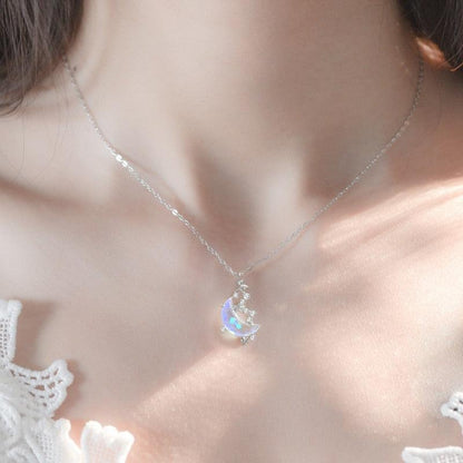 Glazed stone moon pendant necklace with small crystal-like accents on delicate chain
