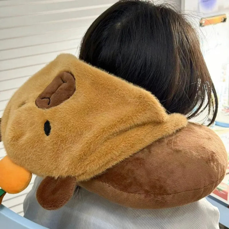 Tan capybara plush neck pillow hat with brown chin button and rounded ear tips.