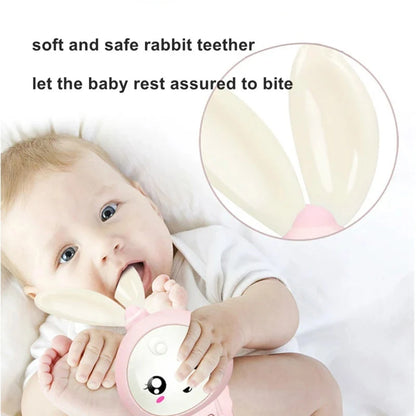 Pink rabbit baby rattle and teether in a baby’s hands
