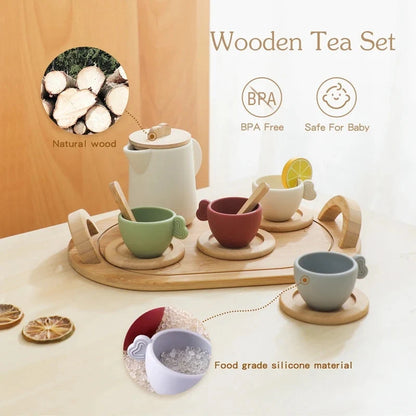 Wooden pretend tea set with white teapot, colored cups, tray, and wooden spoon
