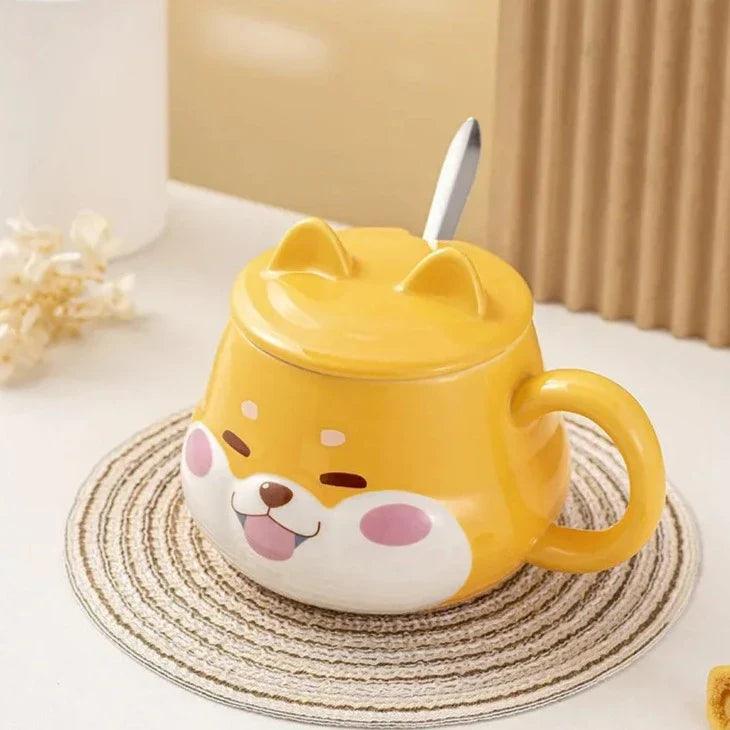 Yellow dog-face mug with lid and side handle, front view on a striped coaster