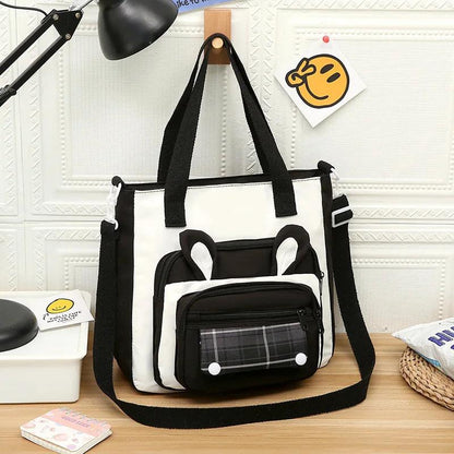 Black and white bunny-ear tote shoulder bag with front plaid pocket and plush charm
