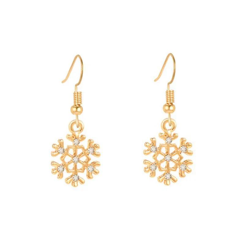 Gold-tone snowflake drop earrings with crystal centers and hanging bead caps