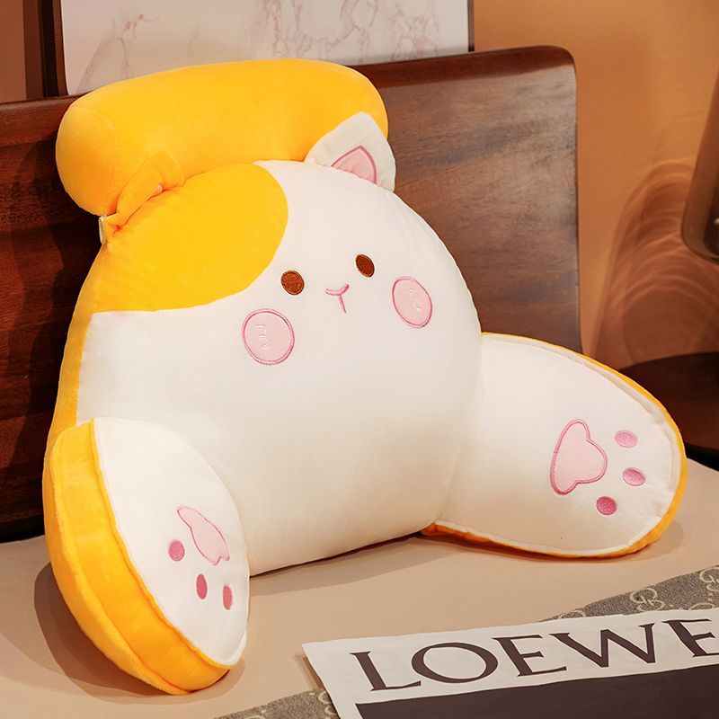 Yellow and white plush reading pillow with smiling character face and cheek spots