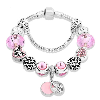 Pink charm bracelet with silver beads and pink stones; heart and leaf pendants