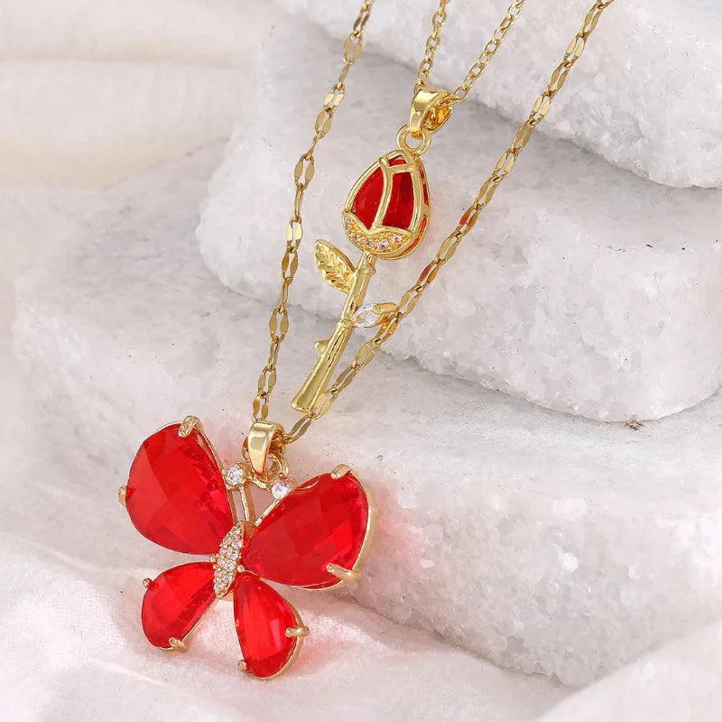 Gold-tone butterfly rose necklace with red butterfly flower pendant and rose stem charm