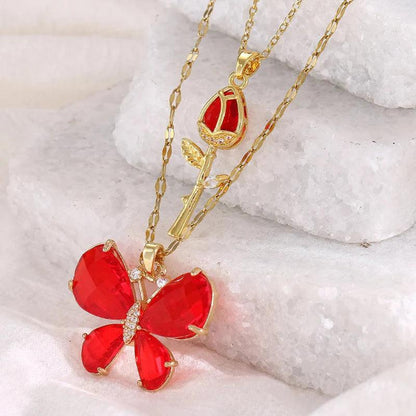 Gold-tone butterfly rose necklace with red butterfly flower pendant and rose stem charm
