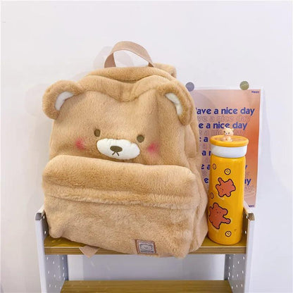 Light tan plush bear backpack with hood-like top and bear face patch on front
