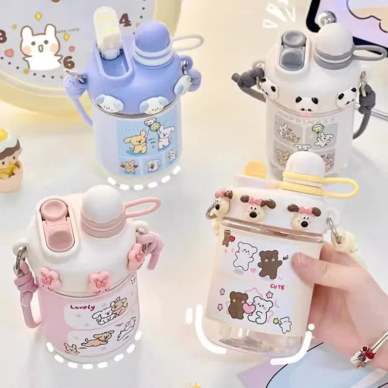 Assorted kids water bottles with straw lids and carry straps, cute animal character prints