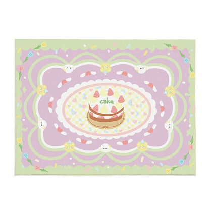 Pastel area rug with central cake illustration, rainbow swirls, and cute animal faces