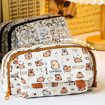 Front view of capybara print pencil bag with centered patch label and orange accents