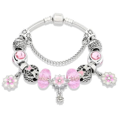 Silver charm bracelet with pink glass beads and flower charms, heart-shaped dangle