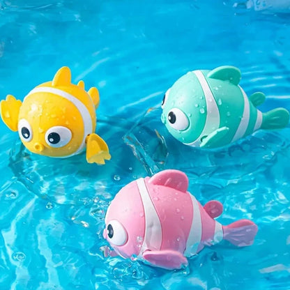 Floating clown fish bath toy trio: yellow, pink, and green striped plastic.