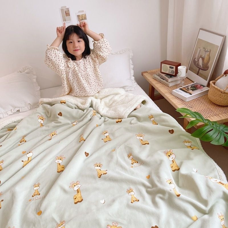 Cream lamb fleece blanket with small teddy bear print, soft plush edge trim.