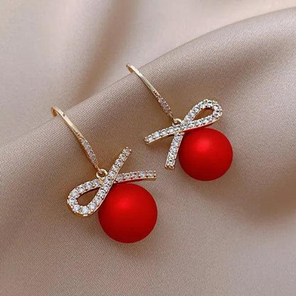 Gold ribbon bow drop earrings with red round charm and rhinestone outline