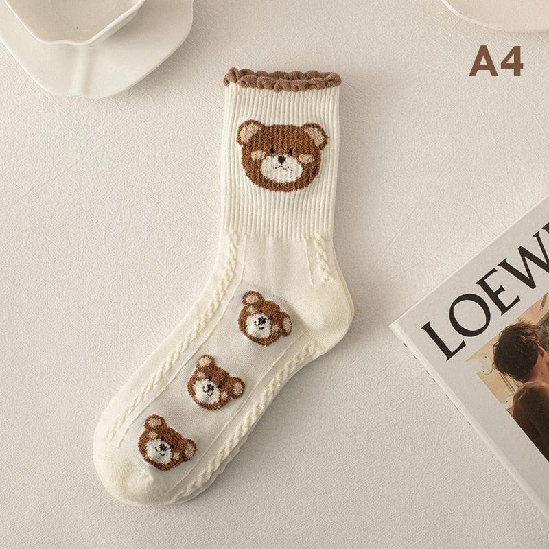 Teddy bear socks in white with a brown bear face and three small bear patches