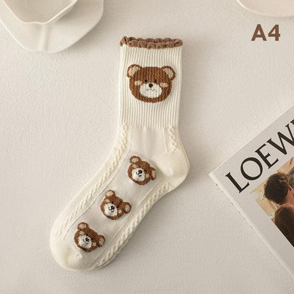 Teddy bear socks in white with a brown bear face and three small bear patches