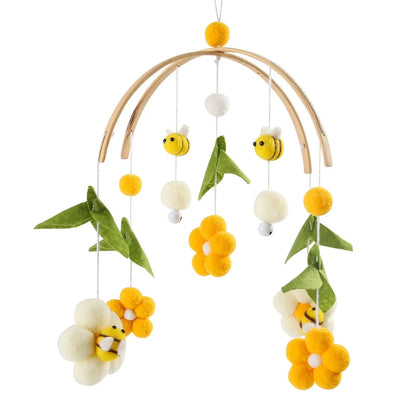 Wooden baby crib mobile with yellow bee plush, flowers, and green leaf charms