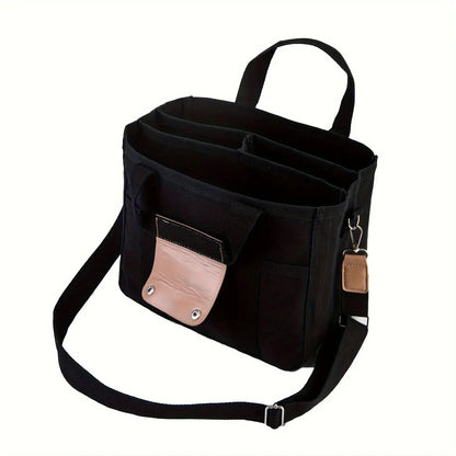 Black canvas crossbody tote with front snap pocket, key clip, and adjustable strap