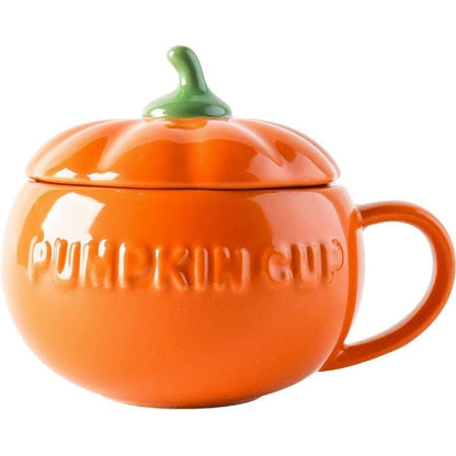 Orange pumpkin-shaped ceramic mug with green stem lid and embossed lettering
