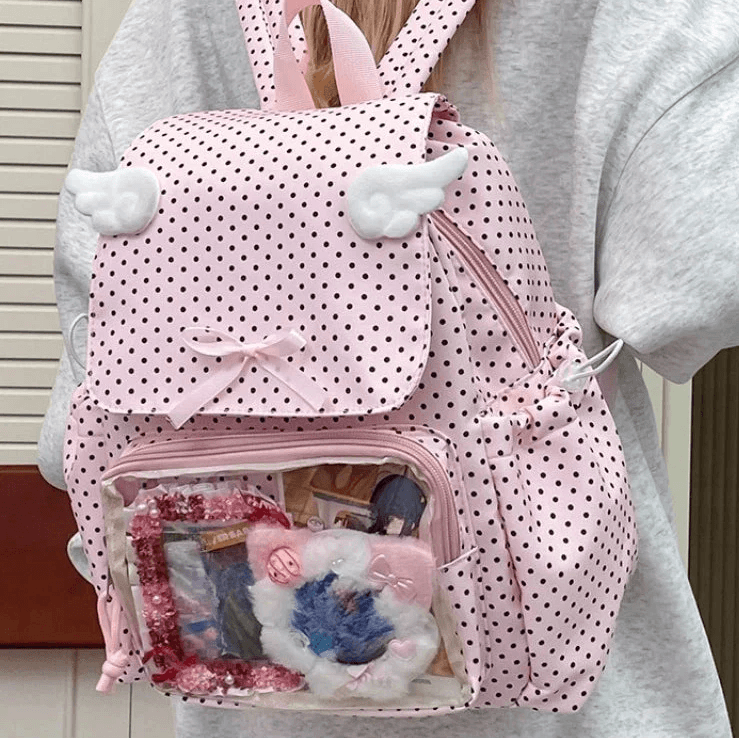 Pink polka dot backpack with plush cloud details, bow, and front zip pocket
