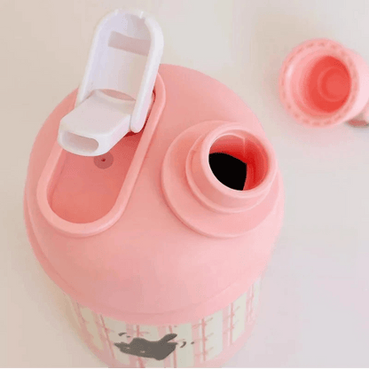 Pink thermos bottle lid with drinking spout and open straw port