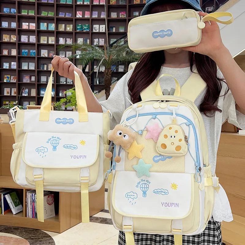 3-piece backpack set in pale yellow/cream with character front panel and top handle