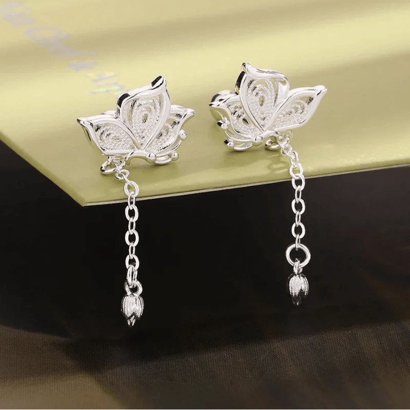 Silver butterfly stud earrings with hanging chains and teardrop dangles
