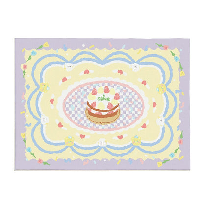 Lilac plush area rug with central cake, rainbow swirls, and cute bunny-face details