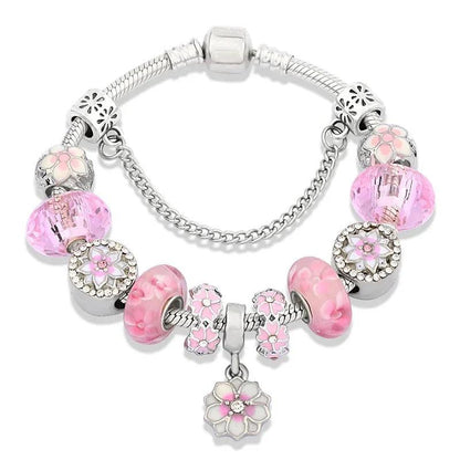 Pink charm bracelet with silver beads, flower and cat charms, central pink glass bead