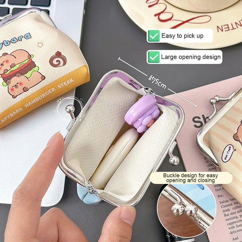 Cream capybara coin purse with metal kiss-lock frame, open top showing interior lining
