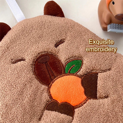 Capybara cotton hand towel close-up with embroidered orange and green leaf details