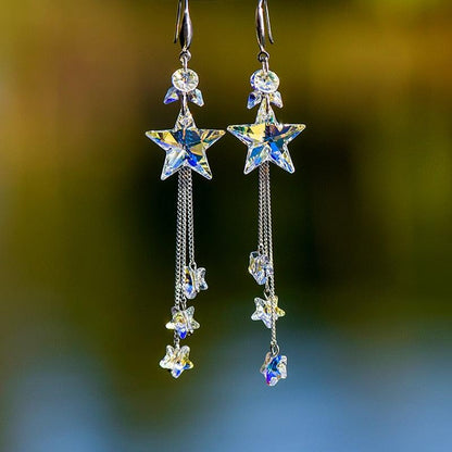 Star dangling earrings with blue and clear crystals on silver chain drops