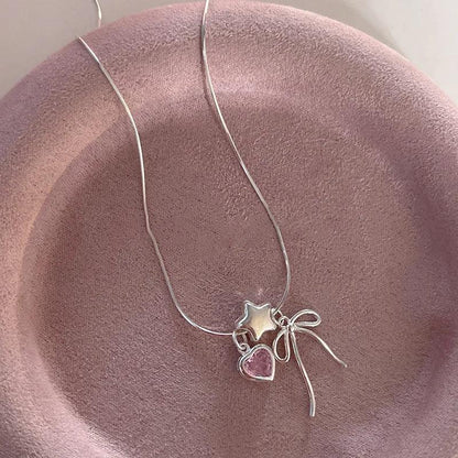 Silver star and heart charm necklace with bow accents and pink heart