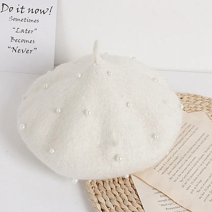 White felt beret with faux pearl embellishments and a small center stem