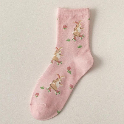 Pink socks with small bunny illustrations and tiny floral accents