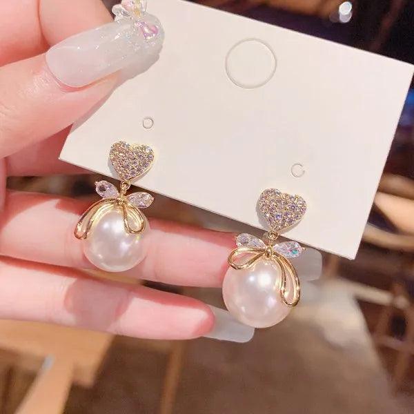 Gold bow and pearl drop earrings with crystal heart and ribbon charms