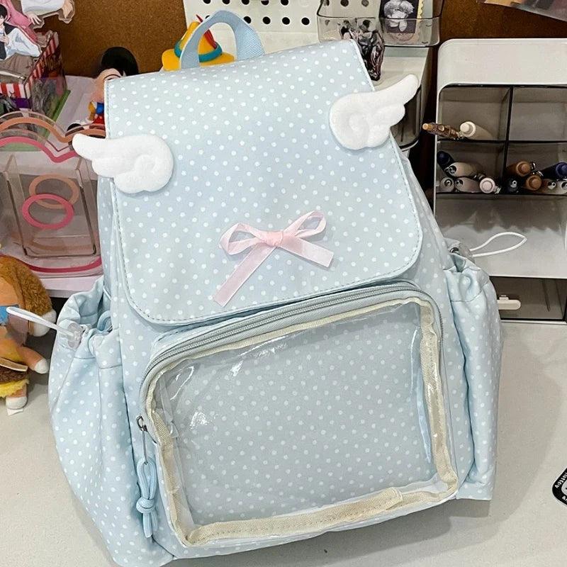 Light blue polka dot backpack with bow, plush cloud handle, and transparent front pocket