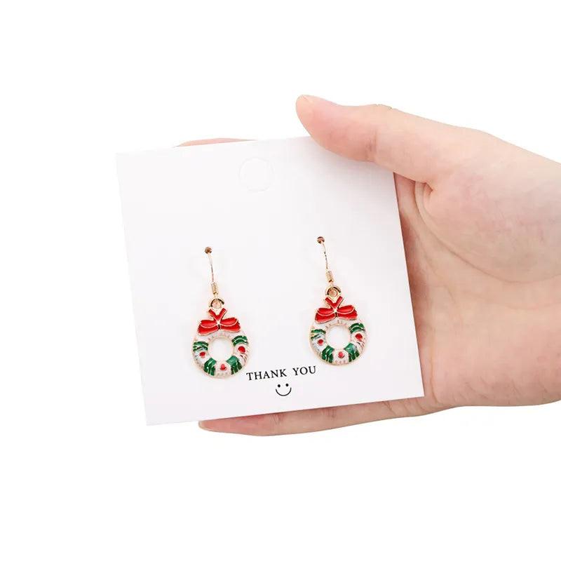 Gold-tone Christmas wreath drop earrings with red bow and multicolor wreath details