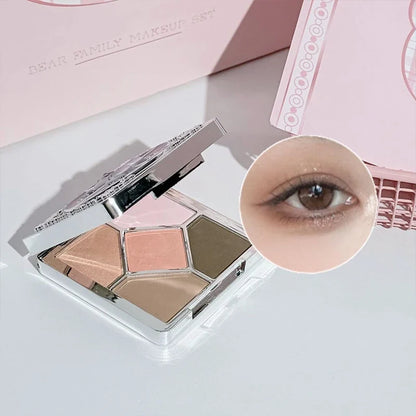 Bear-themed eyeshadow palette with three shades and open compact makeup pieces