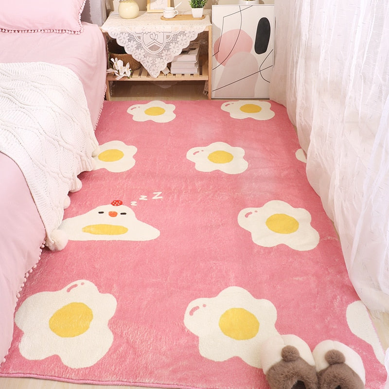 Pink egg-and-flowers area rug with white petals and yellow centers