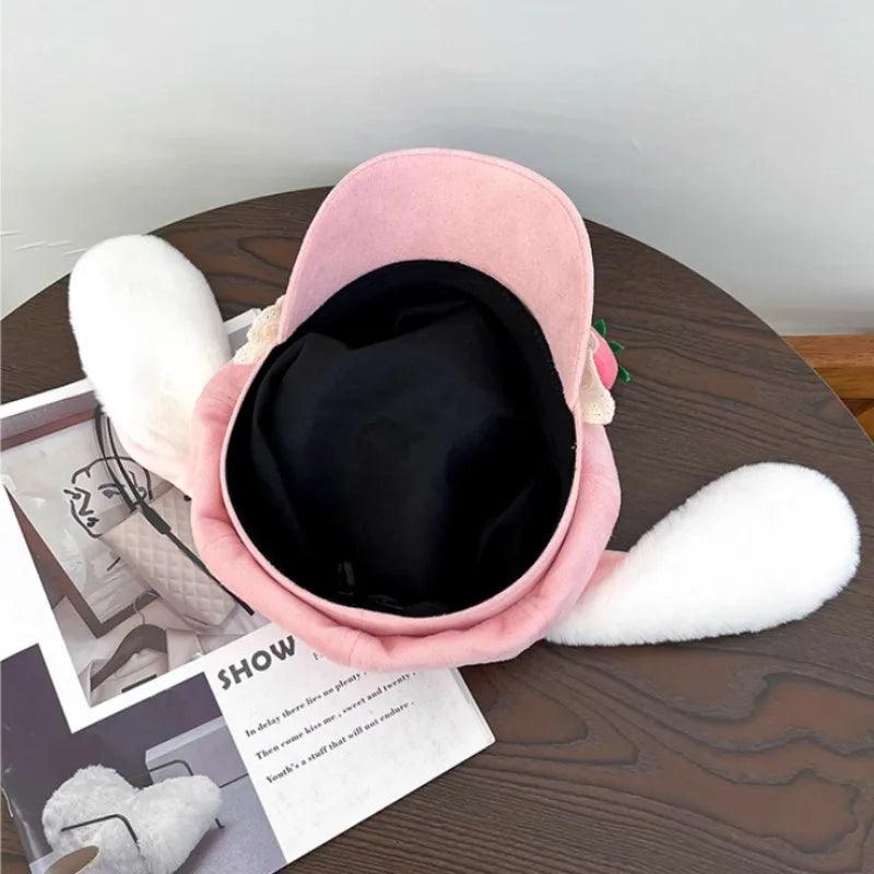 Pink strawberry bunny hat with soft white ear flaps and black inner lining, open front view