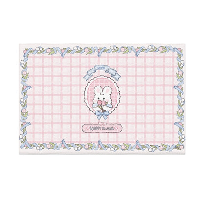 Pastel plush area rug with teddy bear outline art and blue chain border on pink grid background