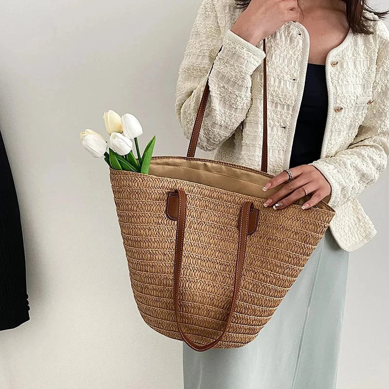 Woven straw shoulder tote bag with brown faux-leather strap and top handles